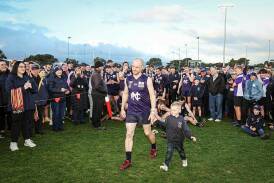 Brayden Harkness, with son Hugo, accepts his best on ground medal after the 2023 grand final. File picture