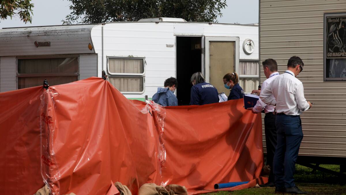 Collecting evidence: Victoria Police forensic services officers examine the crime scene at Port Fairy on Friday alongside homicide squad detectives. Picture: Rob Gunstone