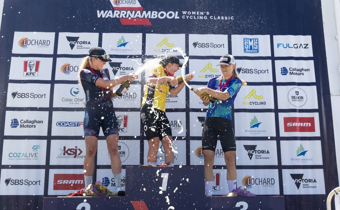 Top-three finishers Josie Pepper, Lucie Stewart and Amanda Poulsen spray each other with champagne on the podium. Picture by Eddie Guerrero