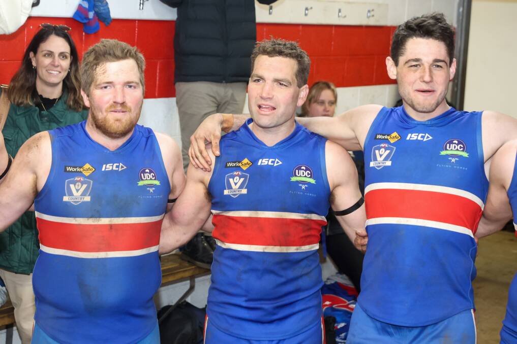 Samuel Mahony, Thomas Wright and Jacob Moloney celebrate a win in Wright's 300th game for the Bulldogs. Picture by Eddie Guerrero