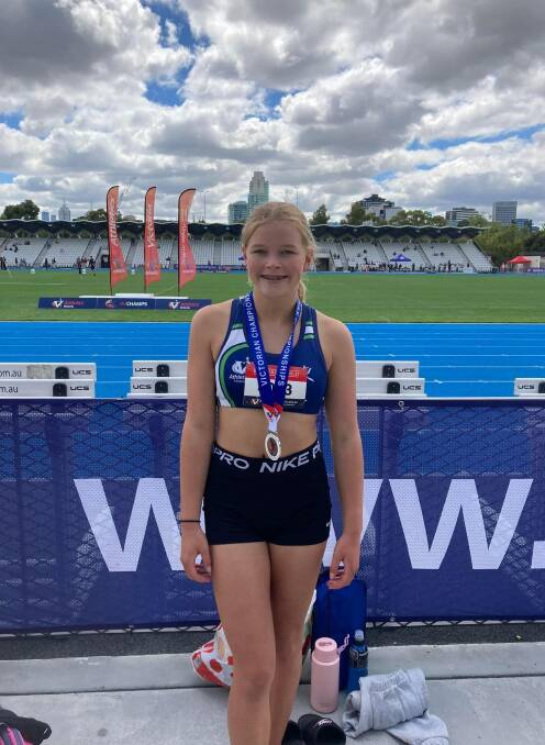 Chloe Mutton poses with one of her silver medals. Picture supplied