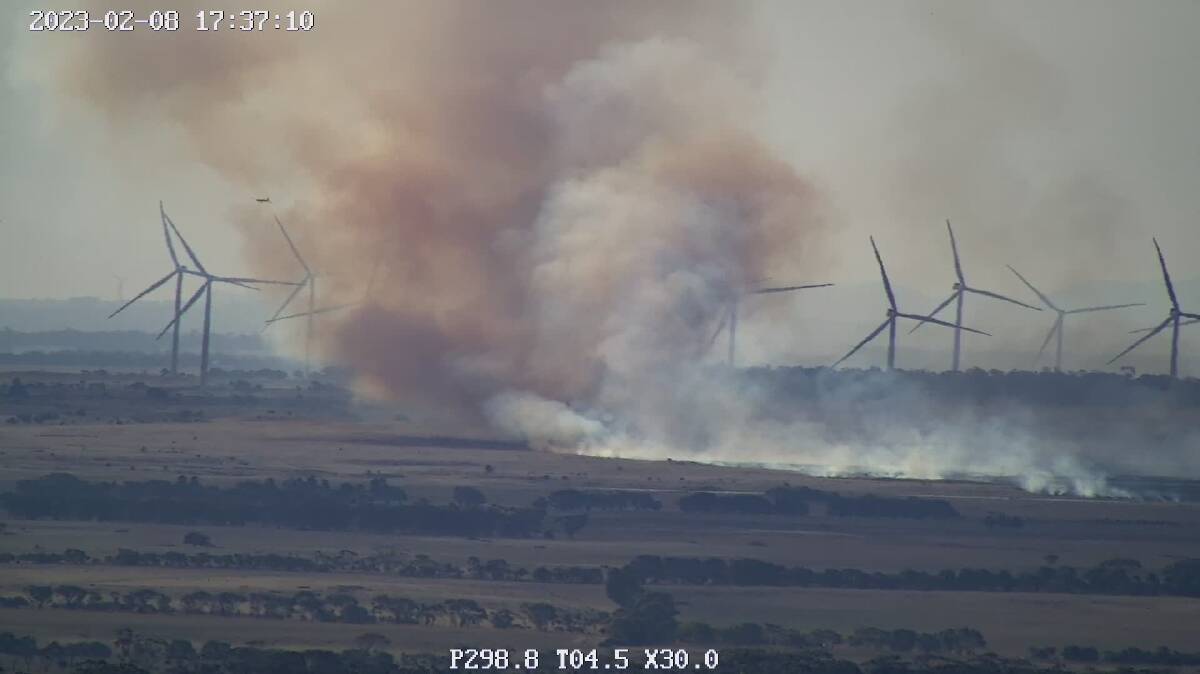 An image taken from the Mount Elephant firecam showing a grass fire burning out of control and moving west in the direction of the Dundonnell Wind Farm, while aerial bombers attempt to douse the flames.
