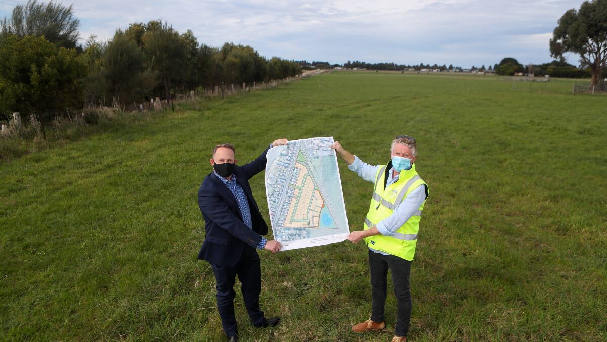 Planning consultant Steve Myers and Developer Michael Hearn pose with plans for the Rivers Run development in Port Fairy in November 2020.