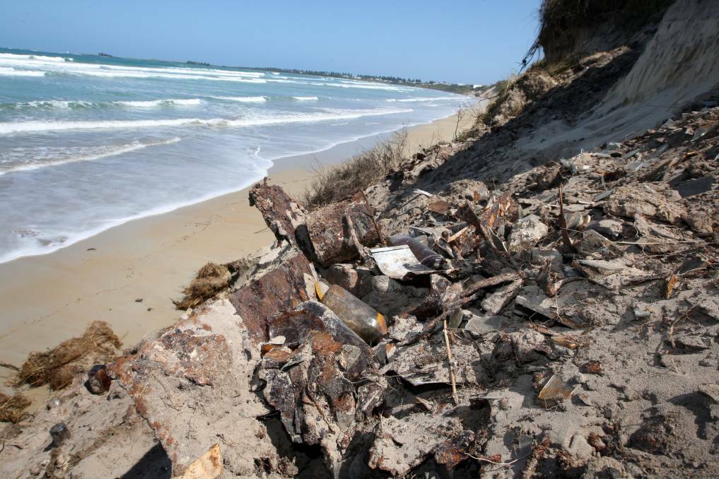 An eroded section of East Beach prior to rock wall fortification being built. Landfill material is exposed from the former tip site. 