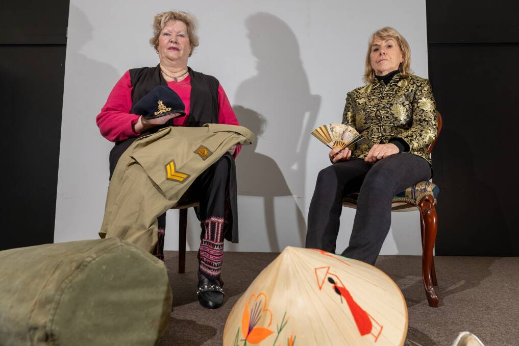 Minefields and miniskirts cast members Trish Storr and Rosie Knight on stage in Terang with items showcasing the Vietnam War. Picture by Eddie Guerrero