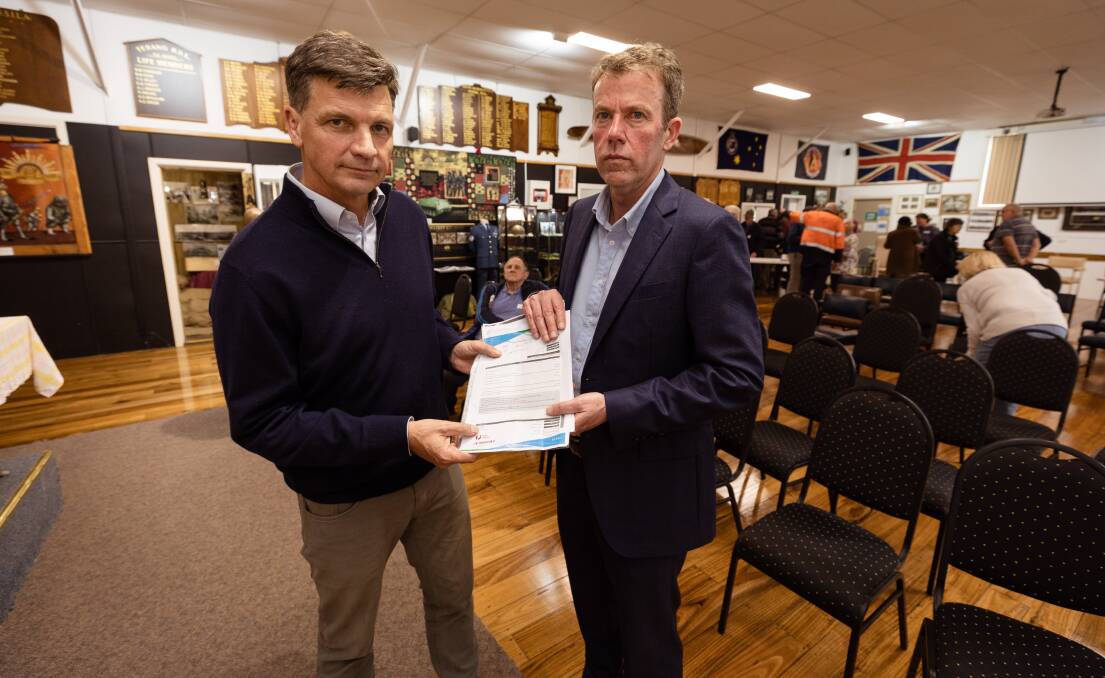 Angus Taylor and Member for Wannon Dan Tehan hold a community members' energy bill at the Terang RSL on Tuesday, August 29. Picture by Sean McKenna