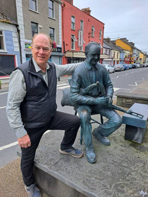 Lake School of Celtic Music, Song and Dance program director Felix Meagher poses with a statue of Irish musician Willie Clancy in Ireland in 2023. Picture supplied.