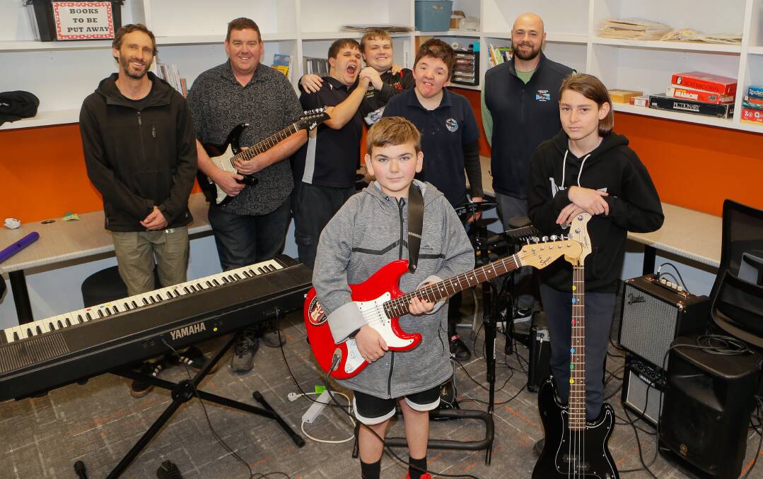 Merri River School teacher Barnaby Hurrell, left, with the school band and 4 Wide's Alan Barnett, second from left. Alan's band is holding a fundraiser for the school to build a music room. Picture by Anthony Brady