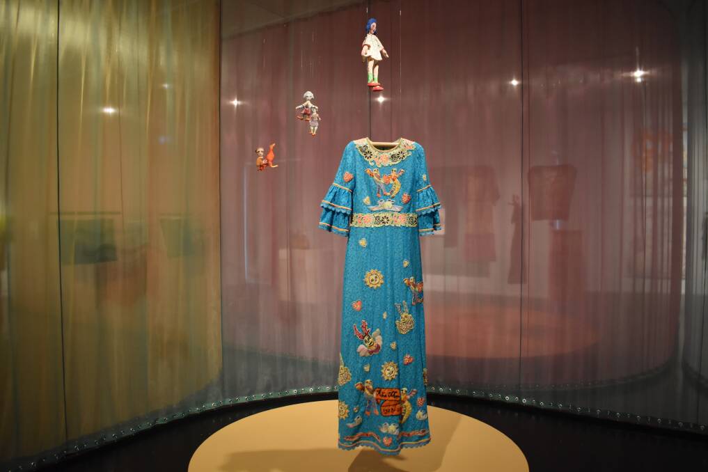 One of the dresses and some dolls on display in the Lisa Gorman and Mirka Mora: To breathe with the rhythm of the heart at Warrnambool Art Gallery.