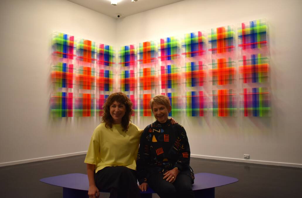 Lisa Gorman with her mother Jane Gorman in front of one of the fashion designers' pieces at Warrnambool Art Gallery. Picture by Aaron Smith