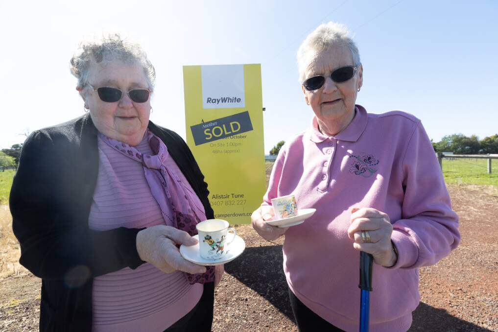 Colac's Marie White and Cobden's Bernadette Brewer holding teacups their uncle Alex Nehill gave them that belonged to the sisters' mother, Mary Howard (nee Nehill). Picture by Sean McKenna.
