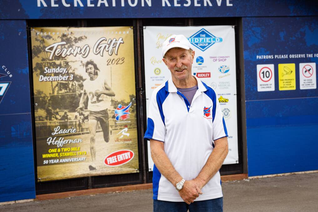 Laurie Heffernan stands in front of a life-sized Terang Gift poster in his honour, found at the front of the Terang Recreation Reserve. Picture by Sean McKenna.