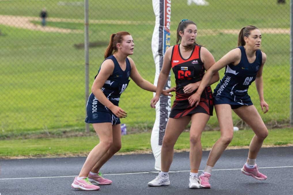 Cobden's Emily Finch fights through two Warrnambool defenders earlier this season. Picture by 