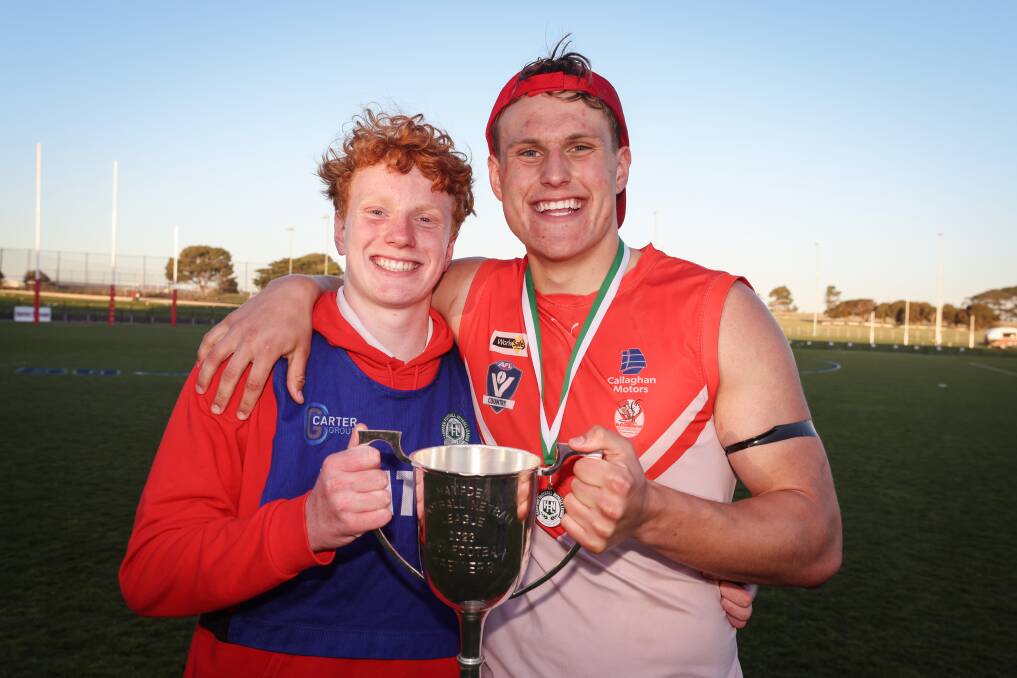 George Stevens (right) celebrates with the cup alongside younger brother Jimmy, who ran water for the Roosters in the senior football grand final. Picture by Sean McKenna