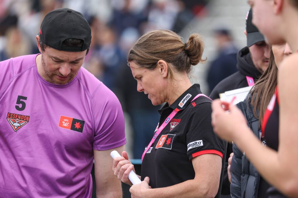 Essendon AFLW coach and Warrnambool export Natalie Wood works with her team at quarter time. Picture by Sean McKenna 