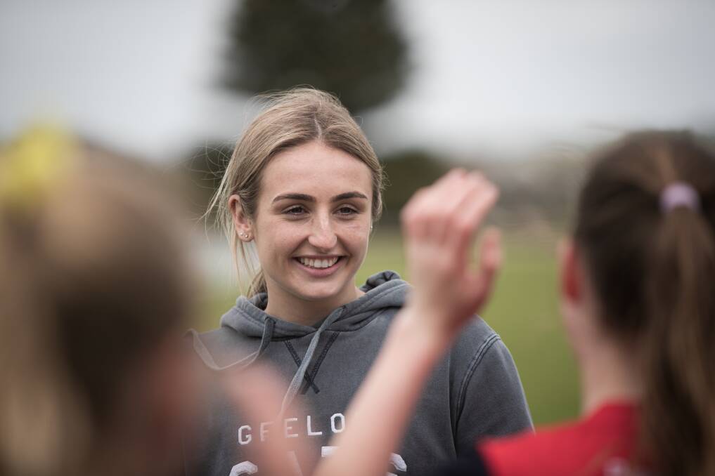 Geelong player Amy McDonald chats with female junior footballers in Warrnambool. Picture by Sean McKenna