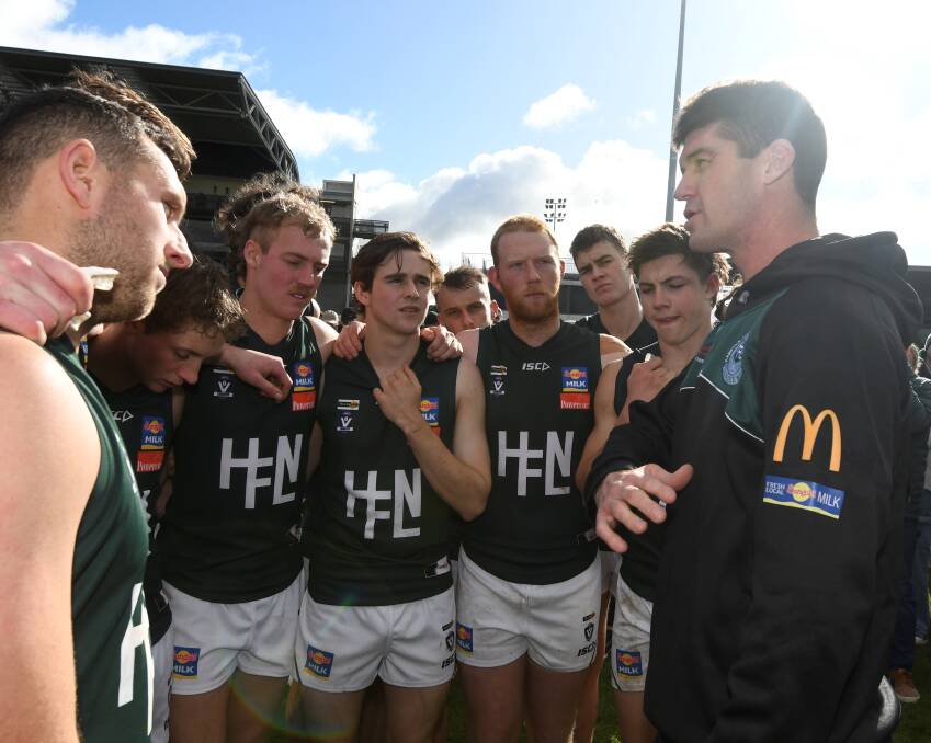 Hampden interleague coach Jonathan Brown (right) revs up his players at a quarter time break on Saturday. Picture by Lachlan Bence