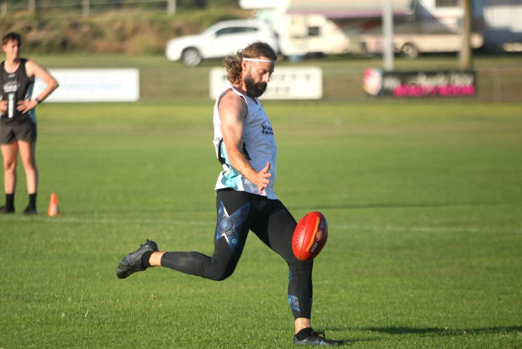 Jeremy Larcombe fires off a pass by foot at pre-season training. Picture by Meg Saultry