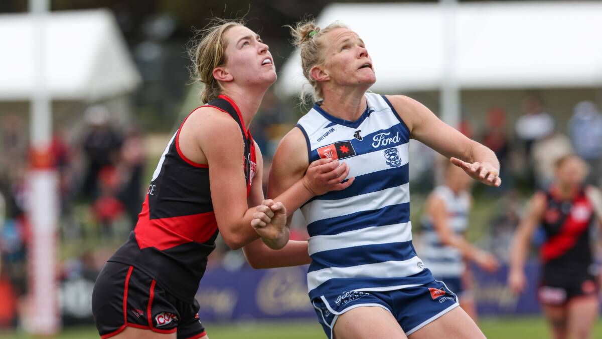 Essendon's Steph Wales and Geelong's Kate Darby compete in the ruck. Picture by Sean McKenna