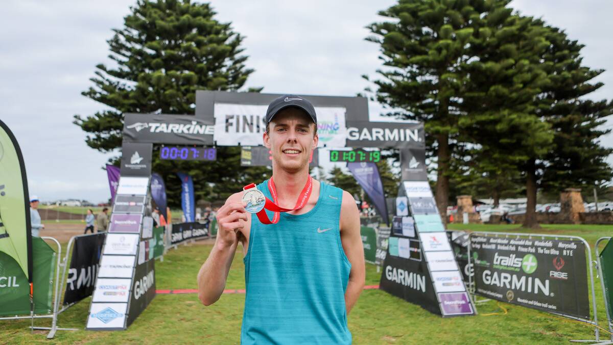 Warrnambool's Josh Bail shows off his medal after winning the 10km race. Pictures by Anthony Brady