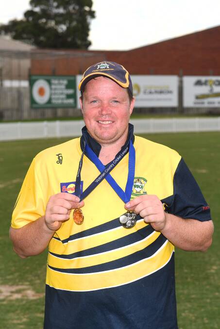 Chris Bant with his haul of medals playing for Warrnambool last year.