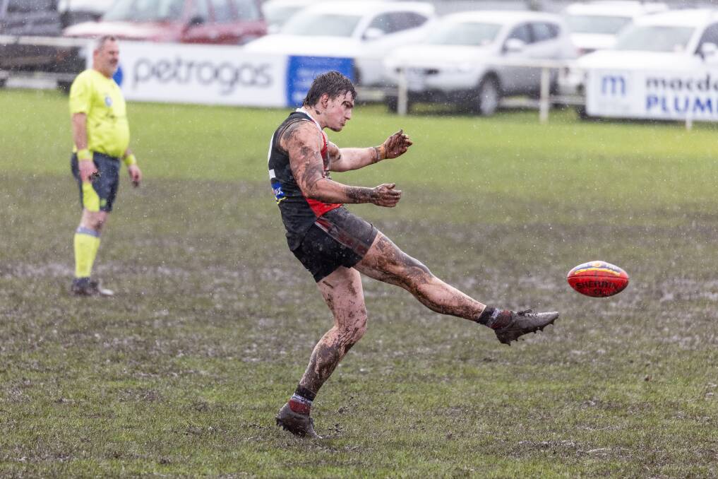 Koroit's Matthew Bradley has a set on goal in the muddy conditions.