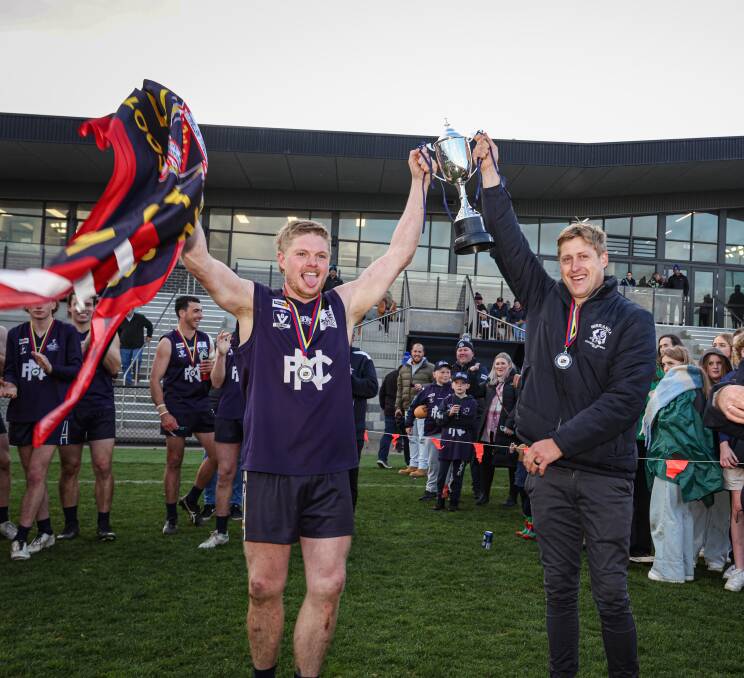 Reagan Nutting and Nick Couch lift up the WDFNL senior football premiership cup. Picture by Sean McKenna