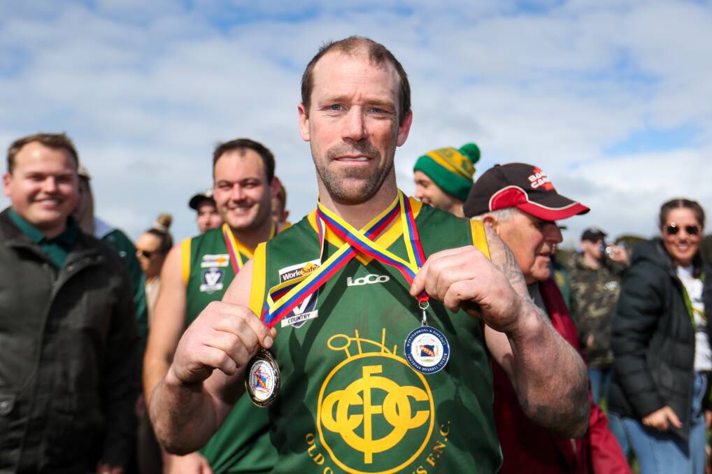 Old Collegians stalwart Nathan Forth, pictured with his 2019 reserves best on and premiership medals, becomes the club's games record holder this weekend. File picture