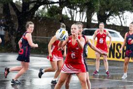 Dennington's Katelyn Grant recieves a pass in the driving rain against Timboon Demons. Pictures by Anthony Brady