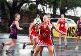 Dennington's Katelyn Grant recieves a pass in the driving rain against Timboon Demons. Pictures by Anthony Brady