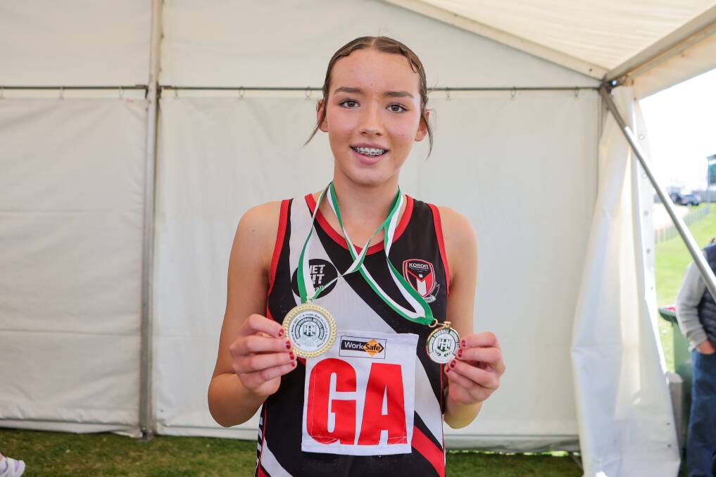 Koroit's Indi O'Connor shows off her best on court and premiership medals after the 17 and under grand final.