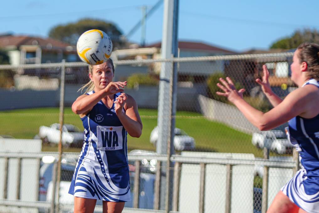 Mid-courter Lisa Pender dishes off a pass for Allansford against Merrivale on Saturday.