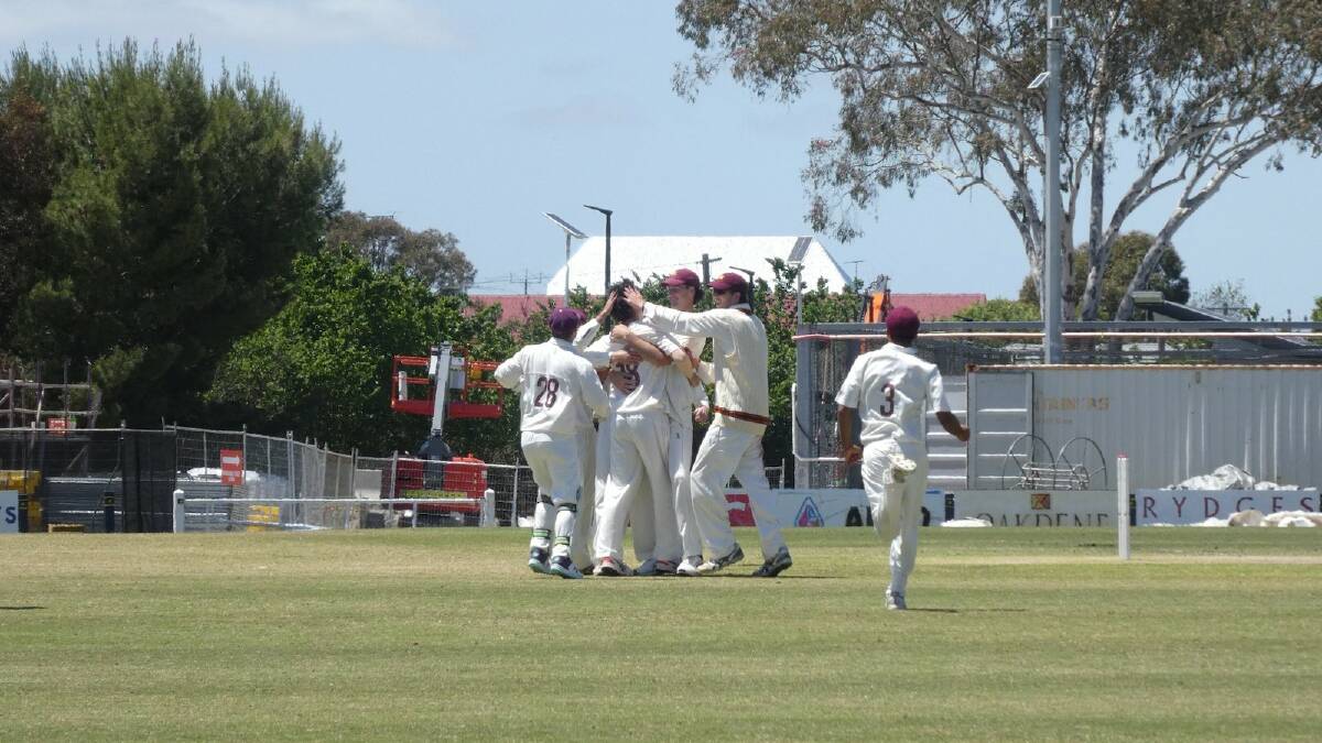 Ethan Boyd is mobbed by teammates after taking his maiden wicket for Fitzroy-Doncaster. Picture supplied