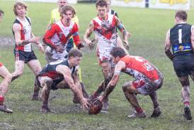 Koroit's Jack Block and South Warrnambool's Liam Youl jostle for possession in the muddy conditions. Picture by Anthony Brady