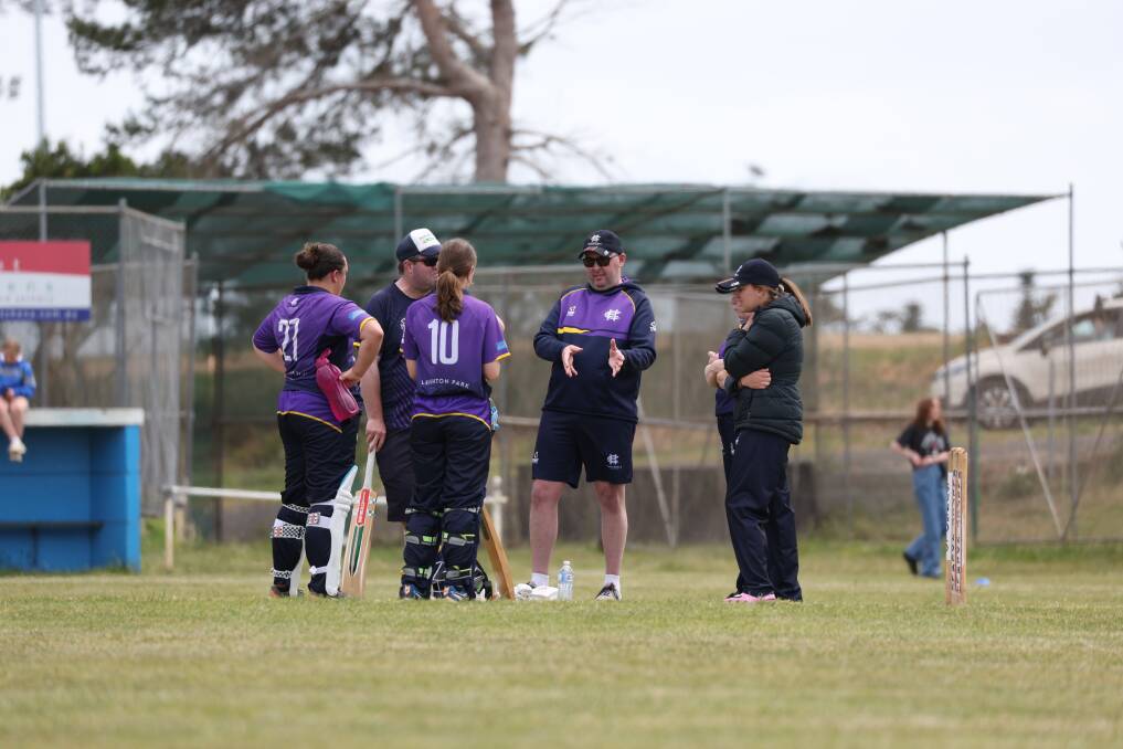 Hawkesdale coach Jason Elliott (middle) chats to his batters during the match.