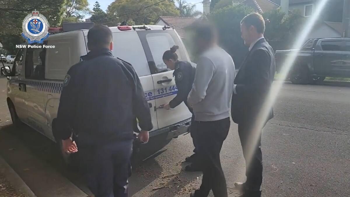 Police arrest the doctor at his Arncliffe clinic. Picture supplied