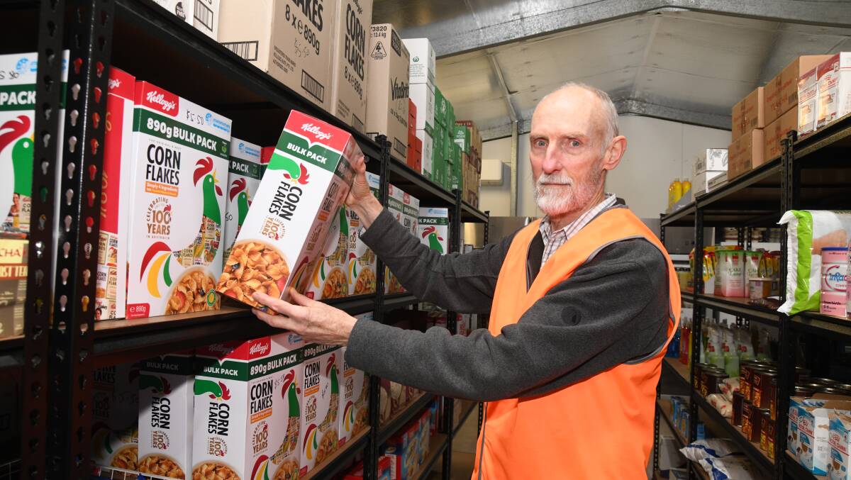Lee Cook stacking shelves at Food Care in Orange. Picture by Jude Keogh
