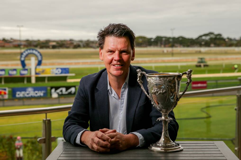 LEGENDARY: Warrnambool Racing Club historian Mark McNamara with the silver cup won by Mossbank in 1909. Picture: Chris Doheny 