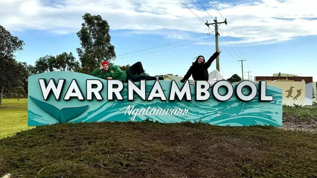 Triple J's Luka Muller and Concetta Caristo pose on the Warrnambool town sign. Picture by Triple J/Instagram