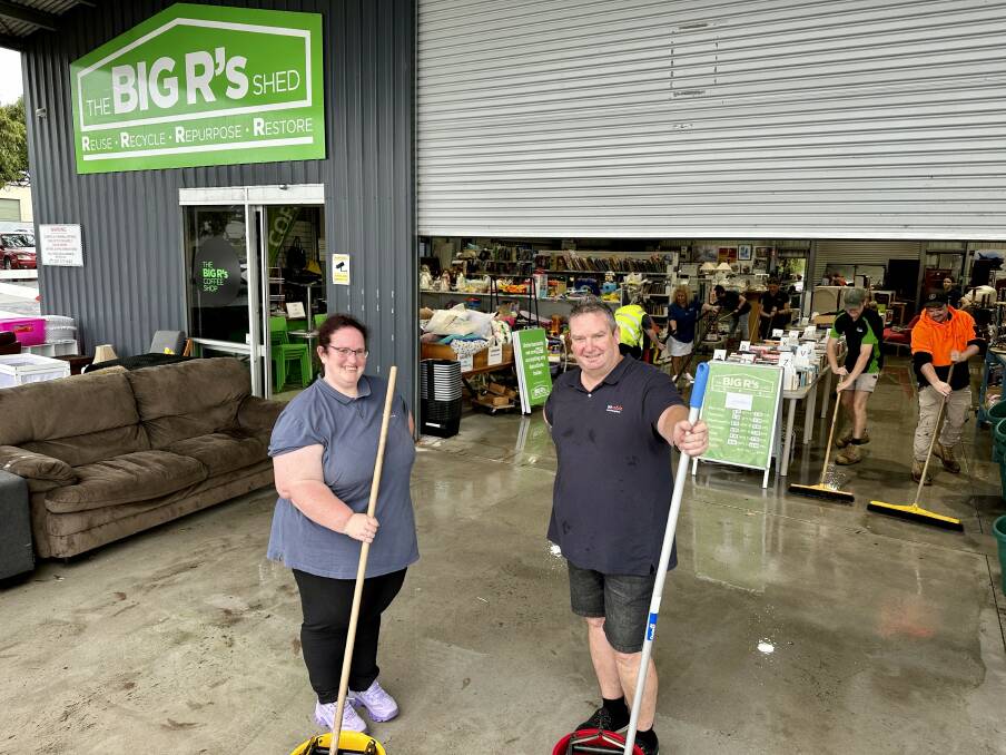Are-able staff members Ami Howe and Paul Hughes mop up the water at the Big Rs Shed on Monday morning. Picture by Katrina Lovell.