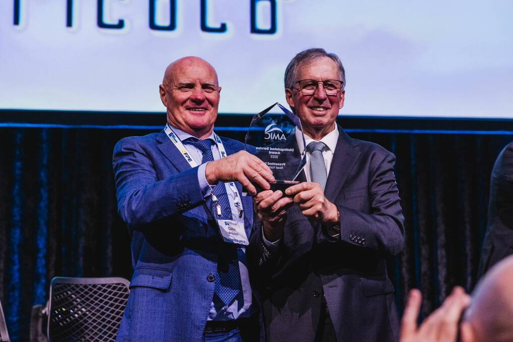 Colin McKenna celebrates the award win with Noel Kelson at the awards ceremony in Queensland.