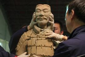 Preservationists working on one of the 8000 Terracotta Warriors. Picture Netflix