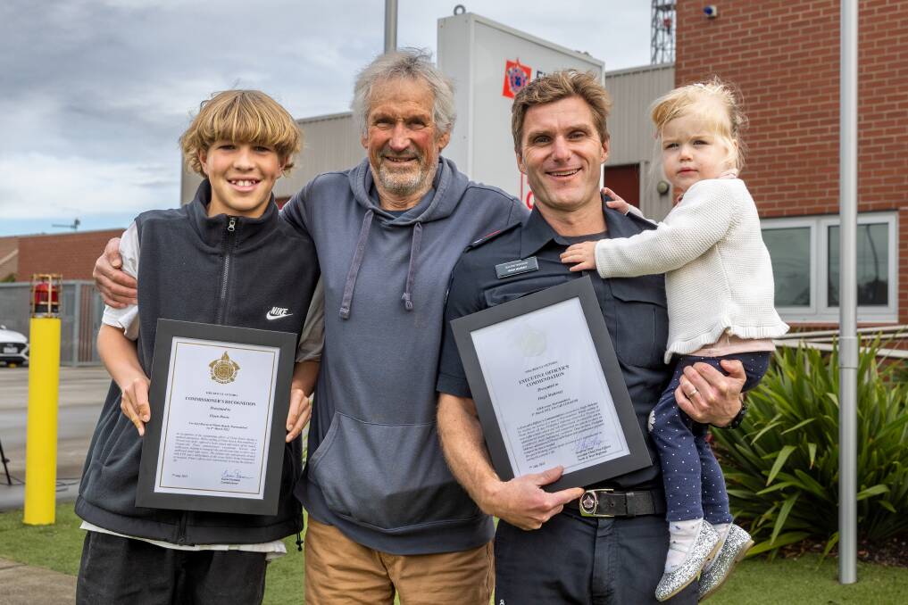 Flynn Dowie, 16, (left) and leading firefighter Hugh Mahony (right) received prestigious Fire Rescue Victoria awards for their efforts saving Garry Druitt (centre) at The Flume in Warrnambool. Hugh is holding daughter Pippa, 2, Picture by Eddie Guerrero