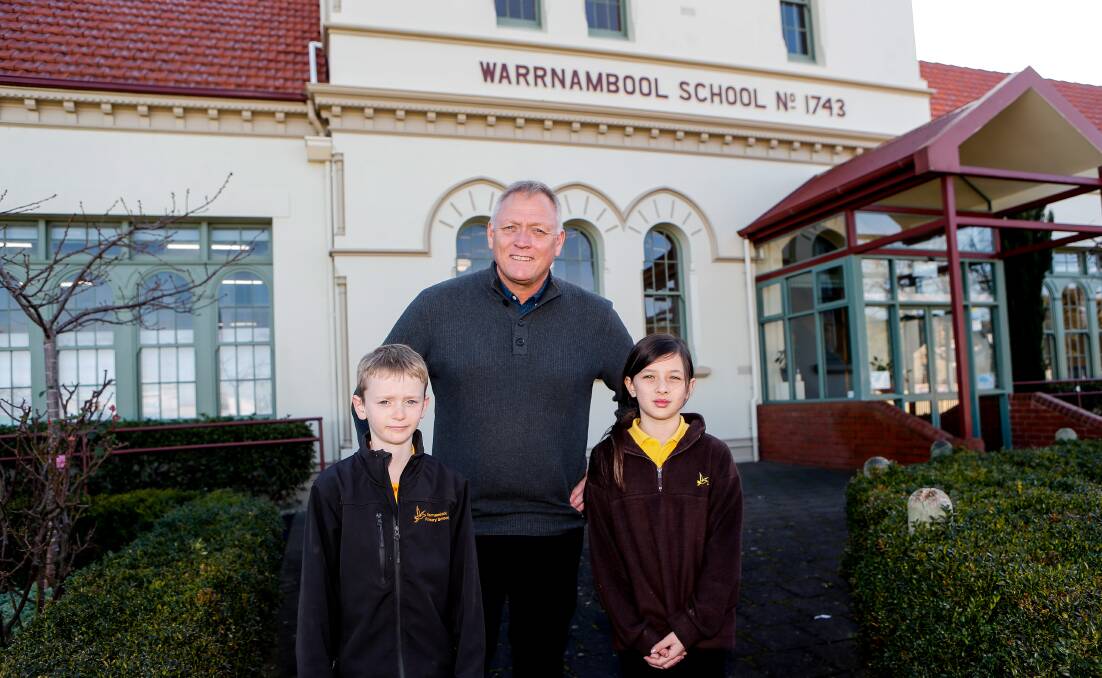 Return: New Warrnambool Primary School principal Peter Lee with students Robert Cleverley and Sophia Elford. Picture: Anthony Brady