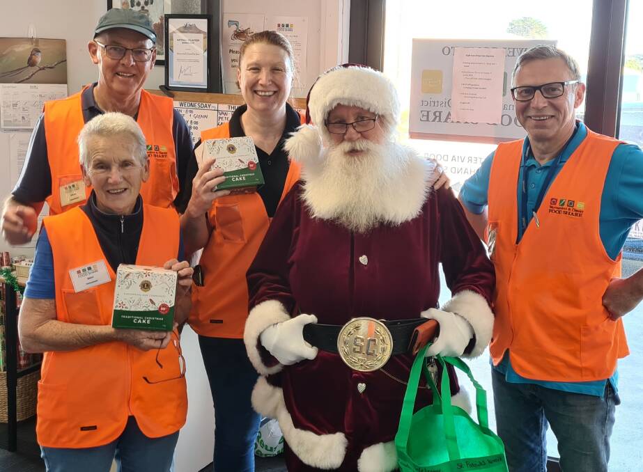 Warrnambool and District Food Share volunteers Shirly Ladhams and Allan McKenzie with warehouse managers Tonia Wilcox and JP Gaston, dressed as Santa.
