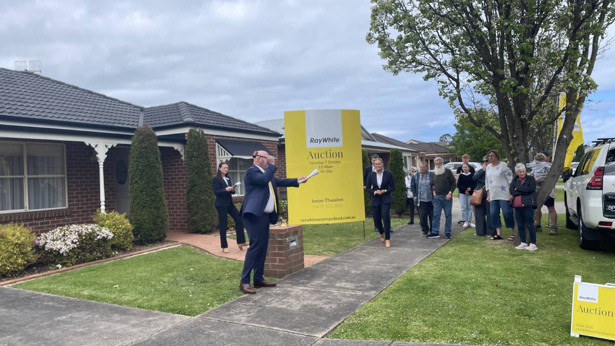 About 65 people watched on as five parties bid for a three-bedroom home at 5 Lutana Grove in the city's north. Auctioneer Jason Thwaites sold the property under the hammer for $620,000. Picture by Madeleine McNeil