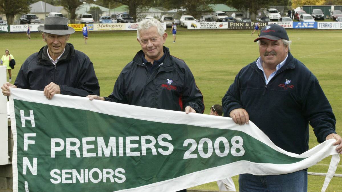 RECENT TIMES: Terang Mortlake club legends l-r Dick Wearmouth, Jim Bell and 2008 club president Jack Mahony with the 2008 premiership flag before the club's 2009 season-opening game against North Warrnambool. Picture: Rob Gunstone