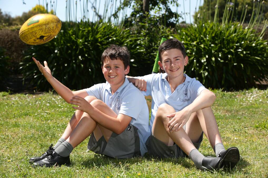 Come so far: James Moloney (left) and nephew Isaac Kenna, here back in grade six, will both line up for Terang Mortlake's senior side on Saturday as James' father celebrates the club's 1979 premiership anniversary. 