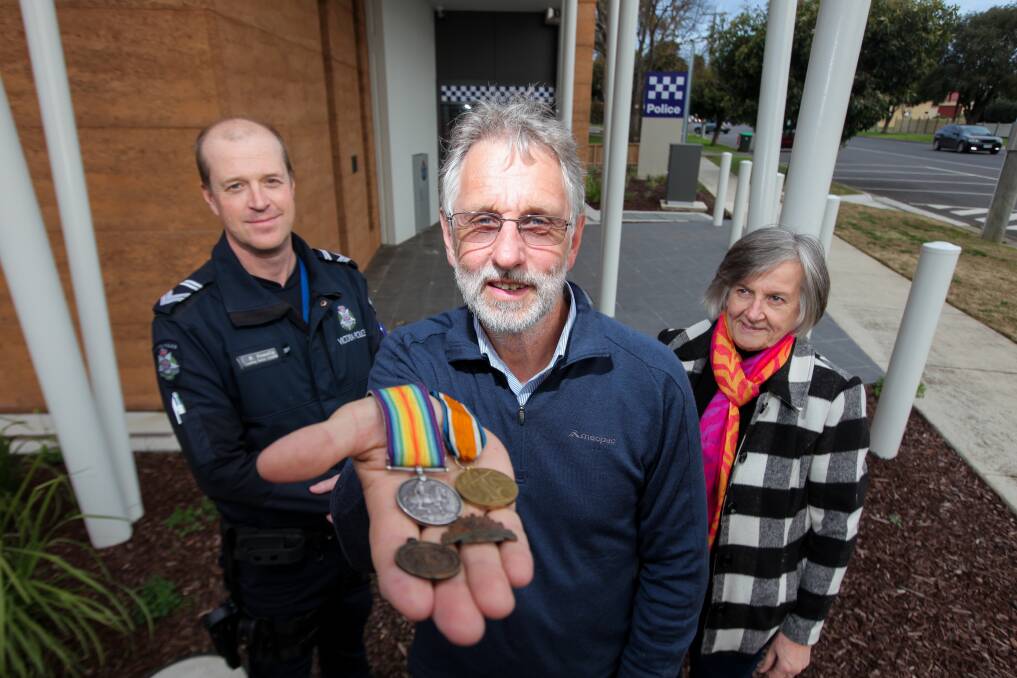 Reunited: Colac's Geoff De La Rue (centre) is delighted to have received his grandfather's WWI service medals back, after being recovered by Colac Police Leading Senior Constable Martin Howells and identified by Merrill O'Donnell, of the Colac and District Family History Group. Picture: Rob Gunstone