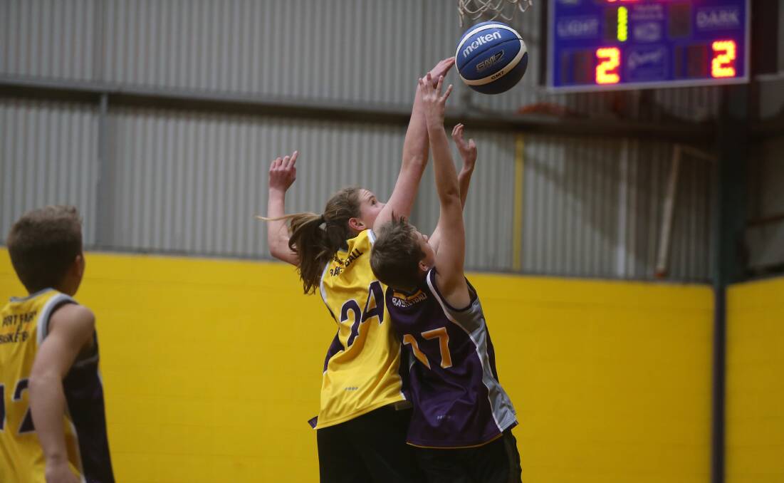 Ball in dispute: Port Fairy Jazz player Eve Covey defends Lakers' Joseph McCall. Picture: Mark Witte